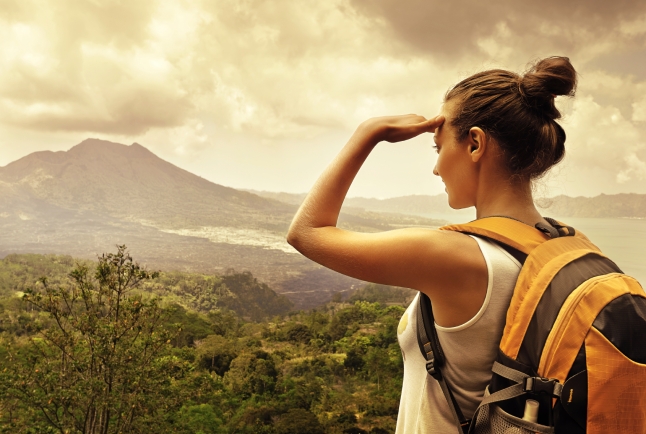 Woman traveler looking at Batur volcano. Indonesia